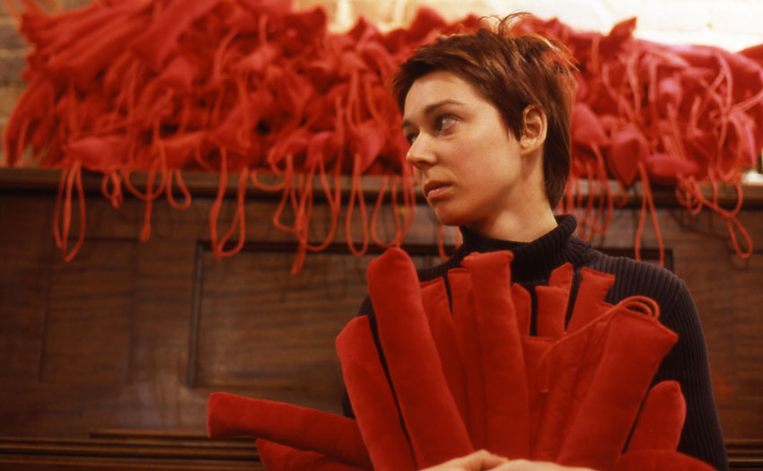 me holding numerous long, red sacks